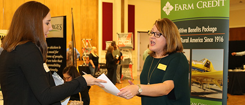 Student handing her resume to recruiter at the Career fair.